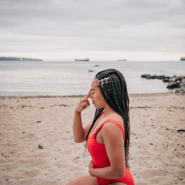 A person sitting in a calm, meditative pose after a workout, with a look of contentment.